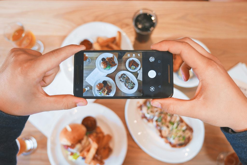 Person taking pictures of food for Instagram